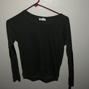 A light sweater with sparkles on the elbow